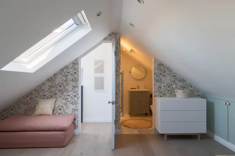 Loft nursery with Scandinavian forest wallpaper and a blush daybed