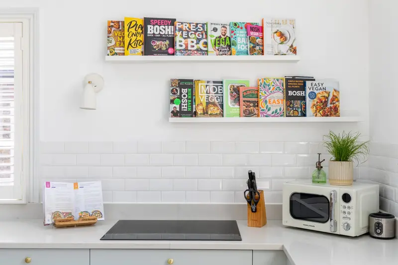 White kitchen with picture-ledge cookbook shelves