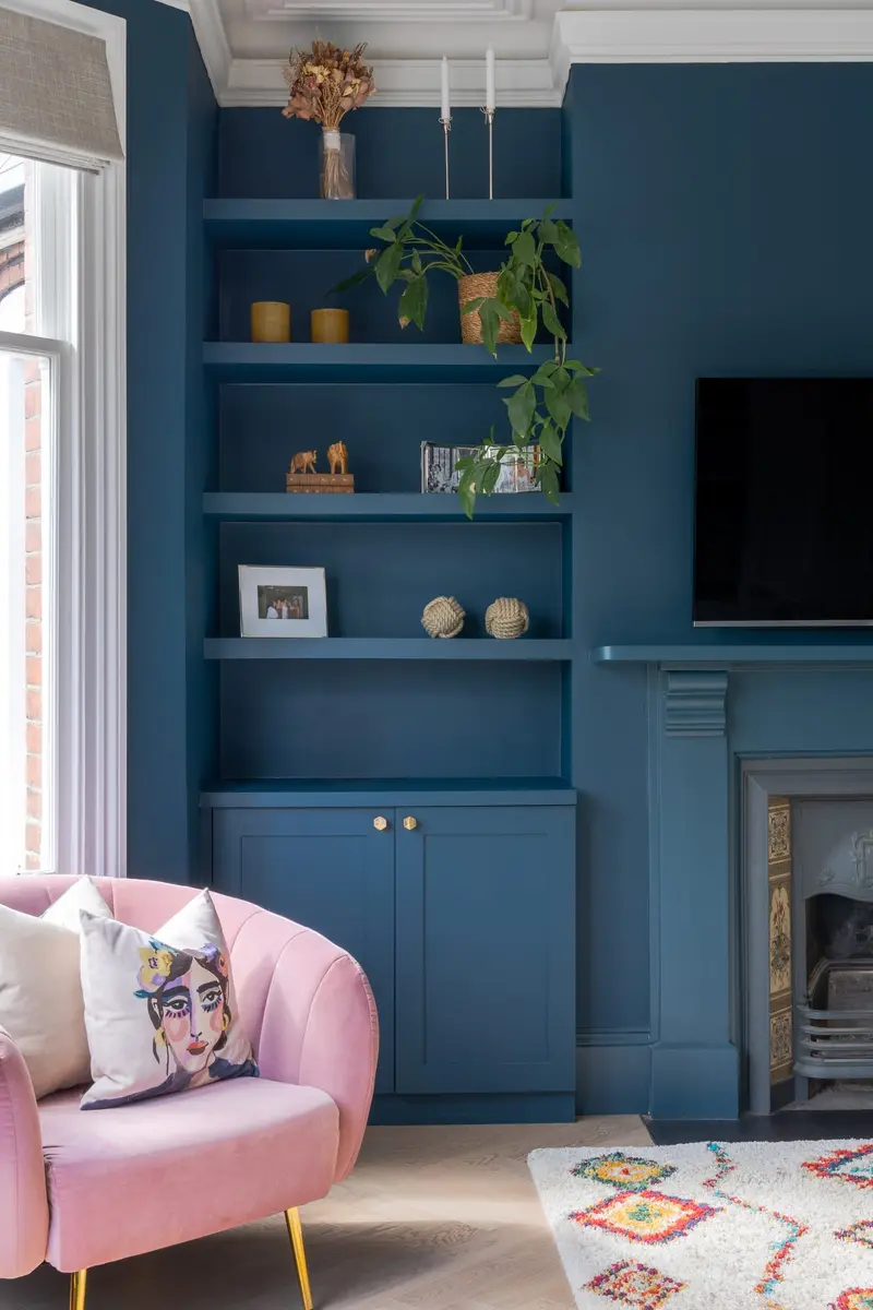 Teal alcove with a pink velvet armchair