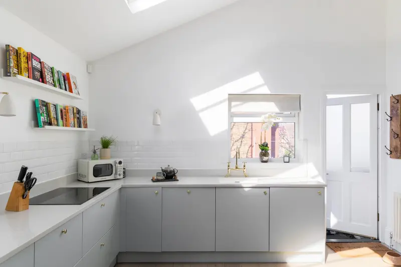 Loft kitchenette with skylight and open shelving