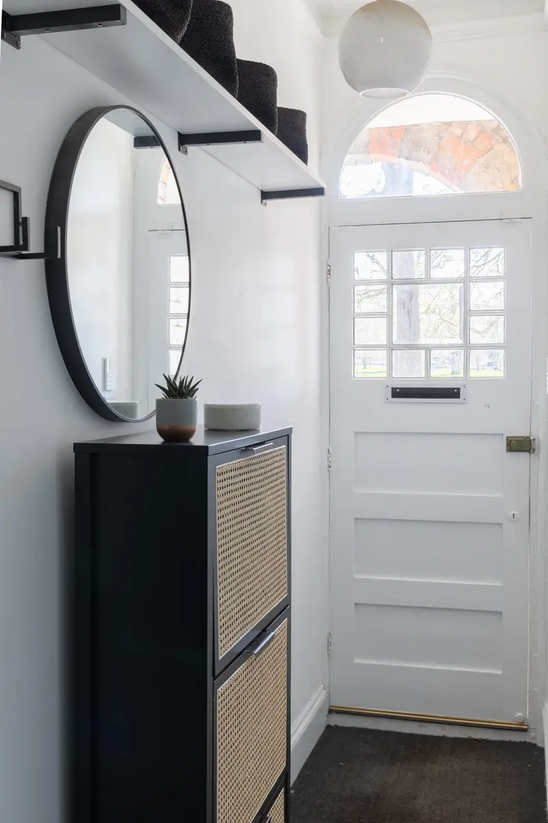 Entrance hall with a round mirror and slim shoe cabinet