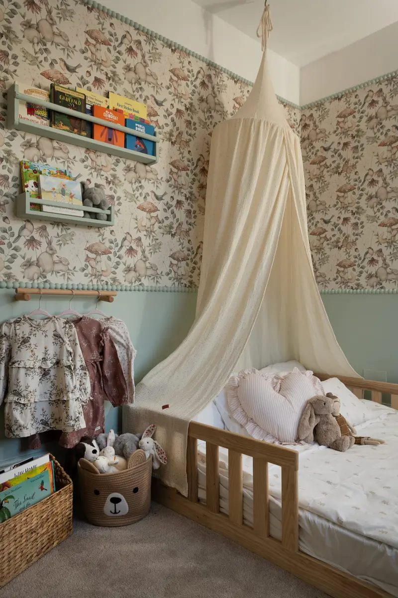 Nursery with botanical wallpaper, canopy and floor bed