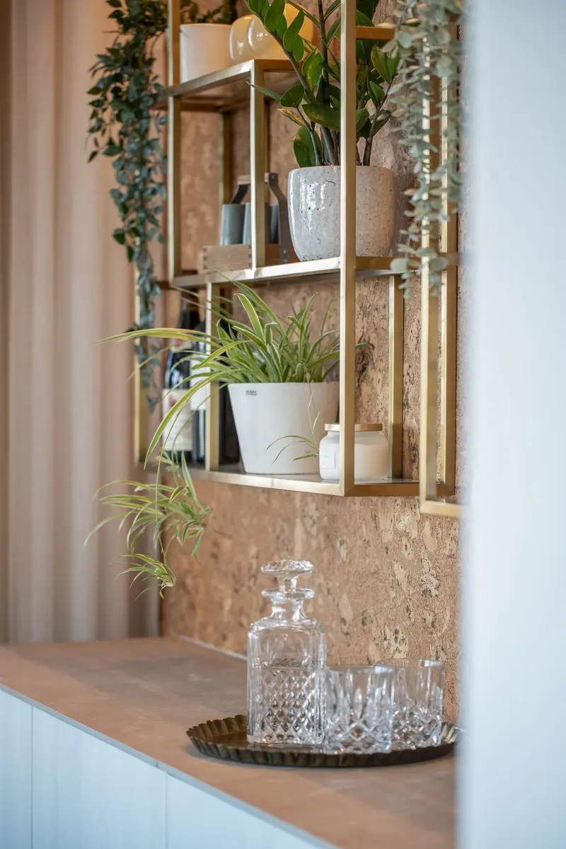 Wood-slat shelving with plants and glassware