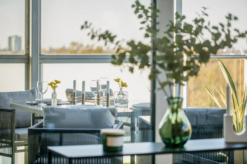 Dining table styled with tulips and a tall glass vase