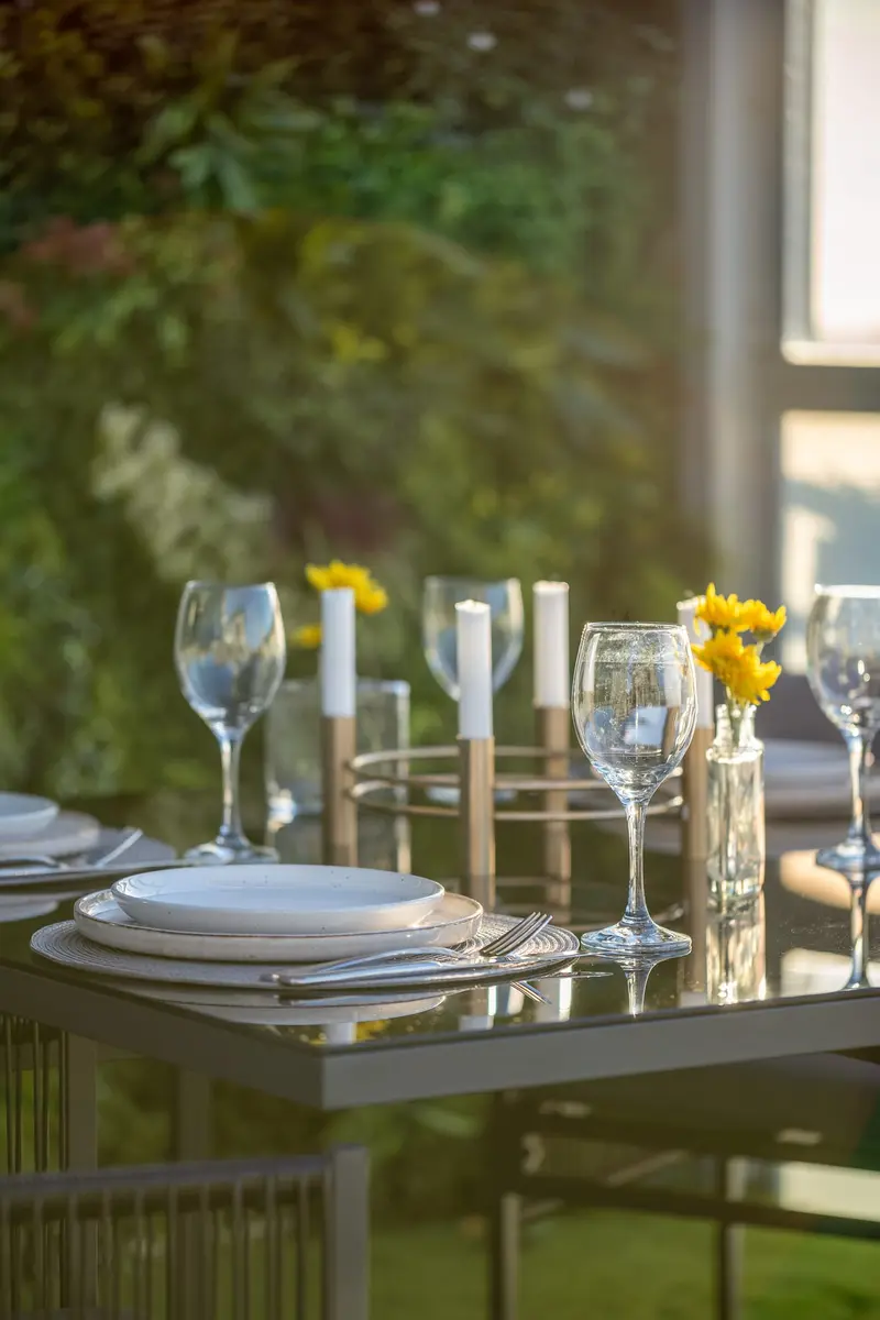 Glassware and yellow flowers on the terrace table