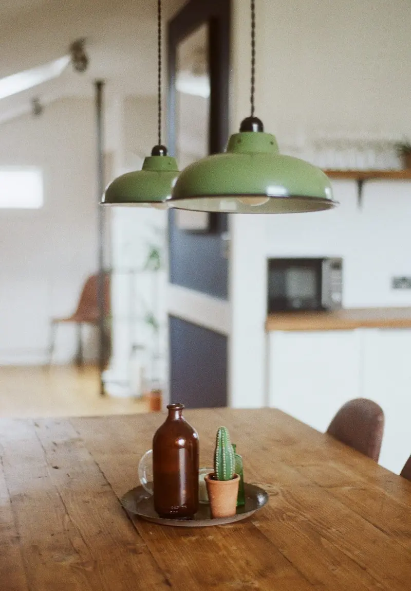 Kitchen table with green enamel pendants
