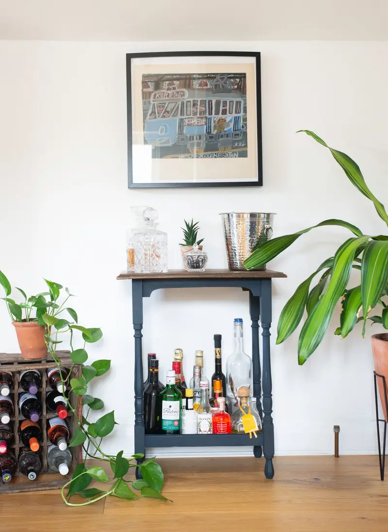 Vintage drinks trolley with plants and framed print
