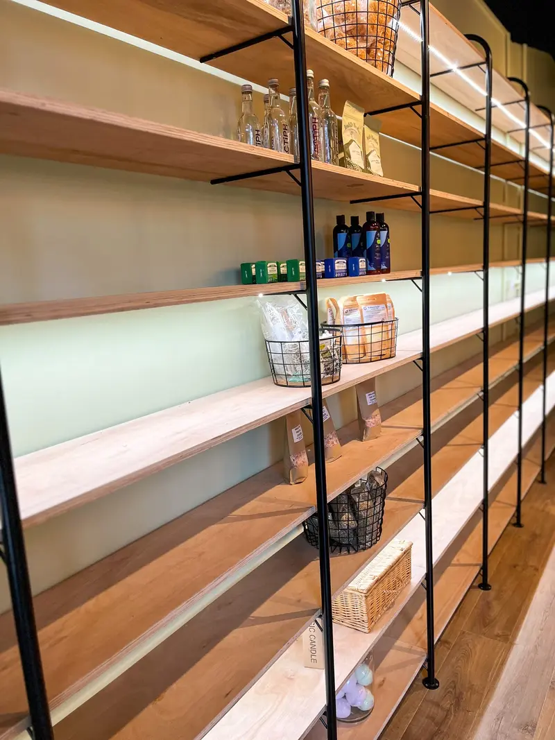 LED-lit oak shelving along the shop wall