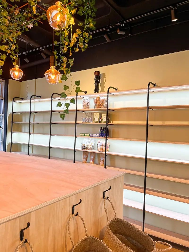 Lit shelving and greenery canopy