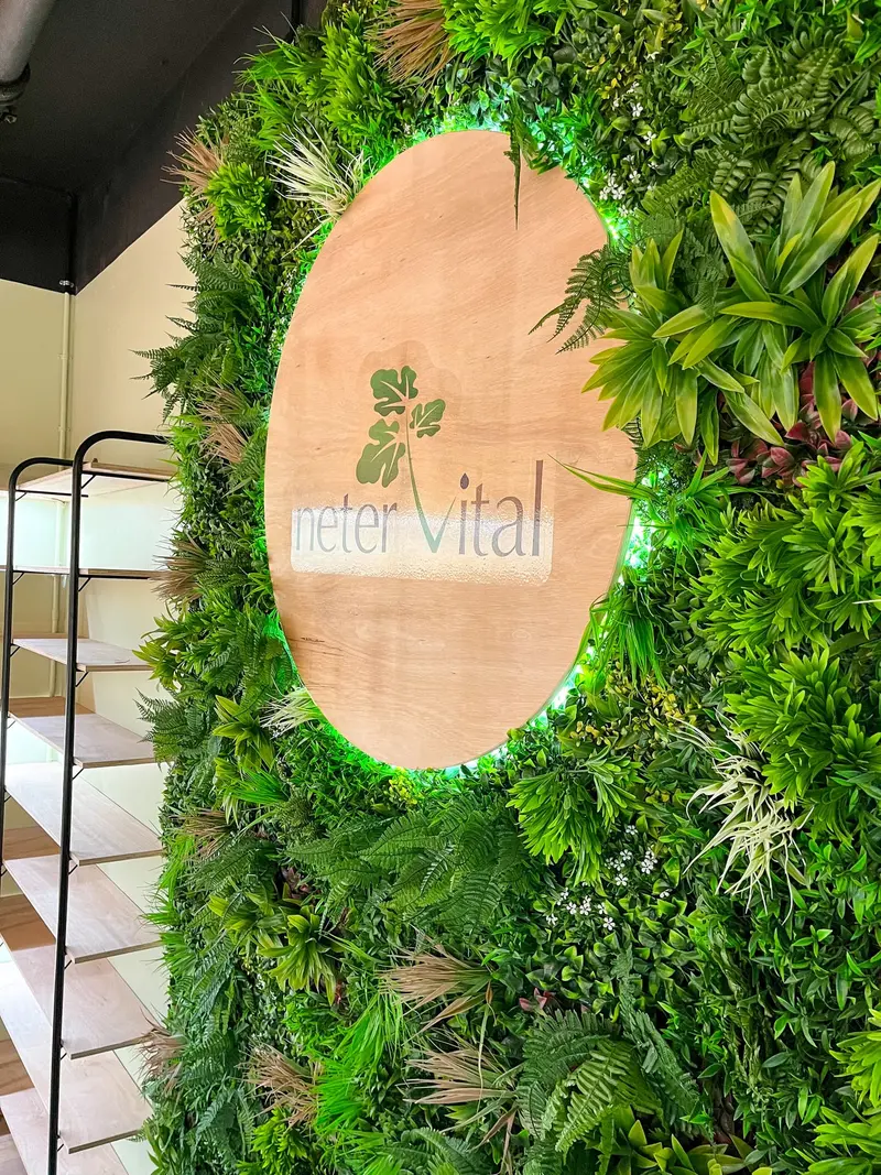 Living moss wall with the shop’s timber logo