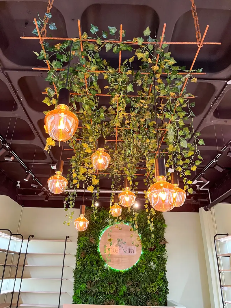Greenery canopy above the logo wall