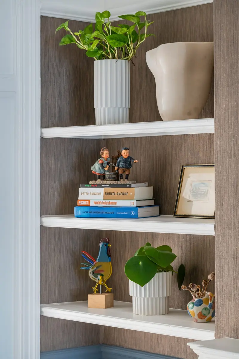 Alcove shelving styled with plants and books