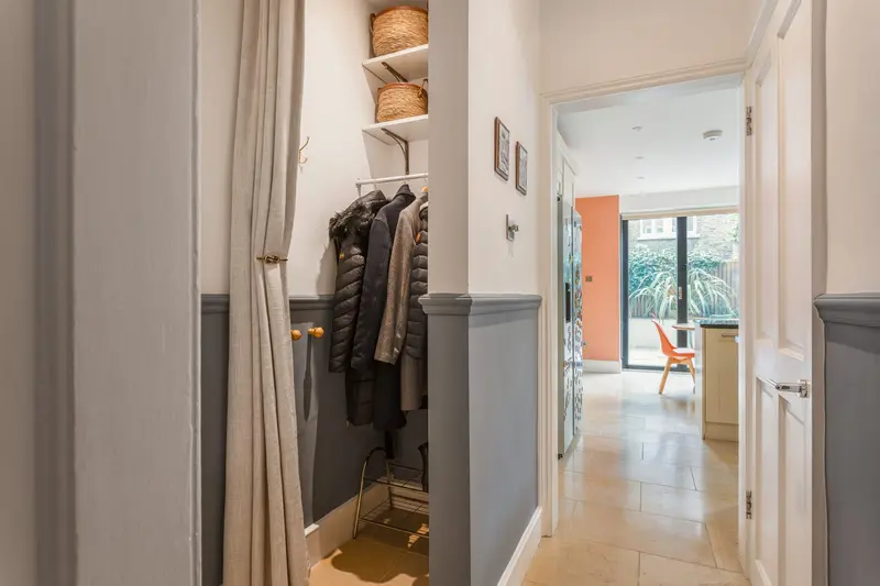 Hallway with a two-tone painted wall and coat storage