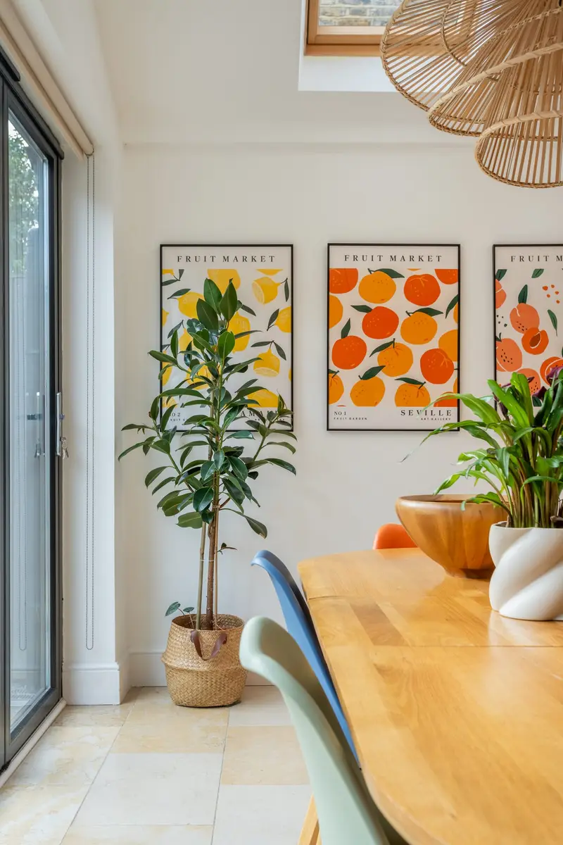 Dining area with citrus prints and an oak table