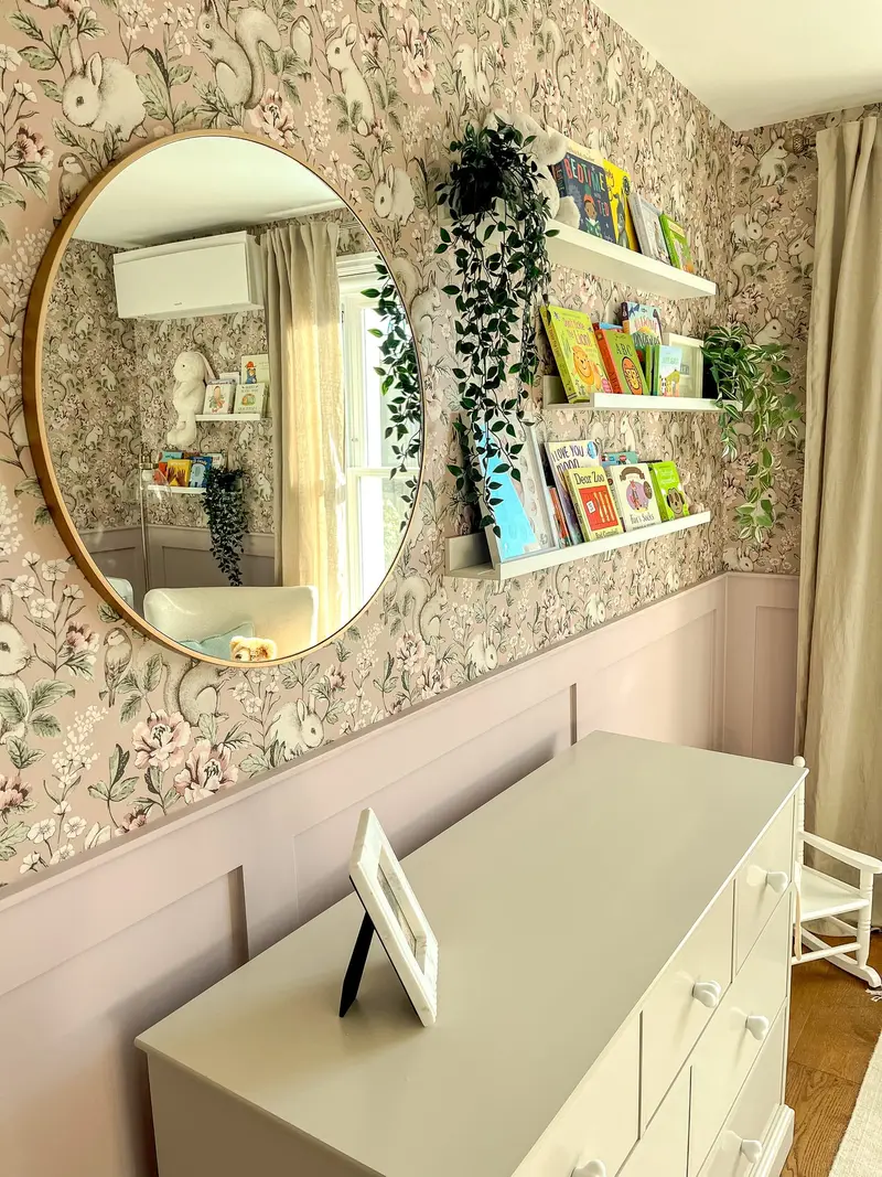 Children’s chest of drawers beneath a round mirror