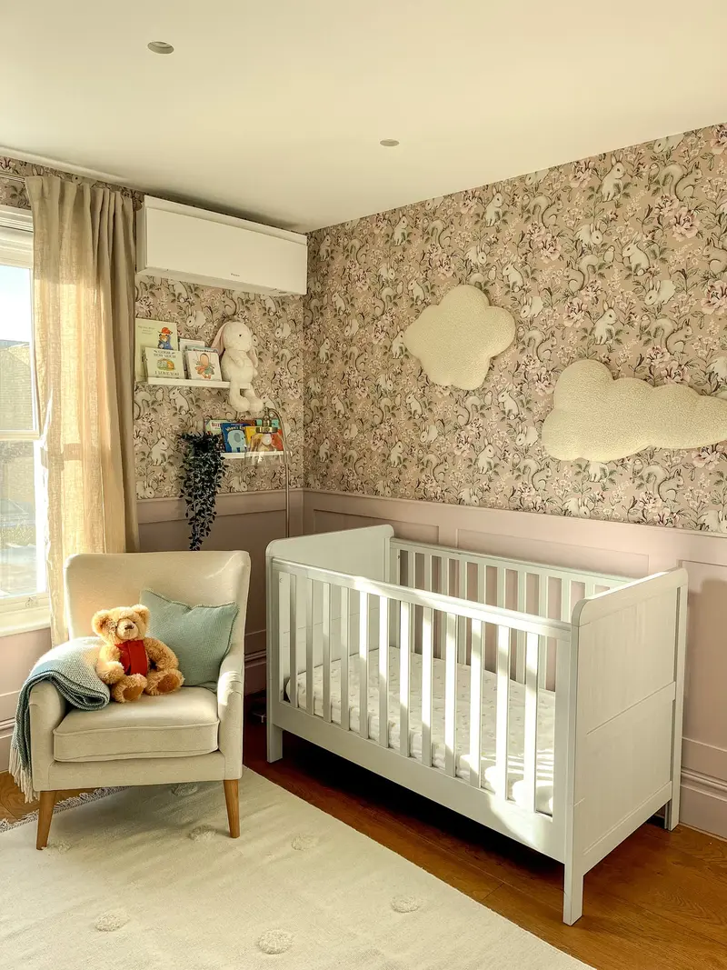 Nursery with a white cot and cosy armchair