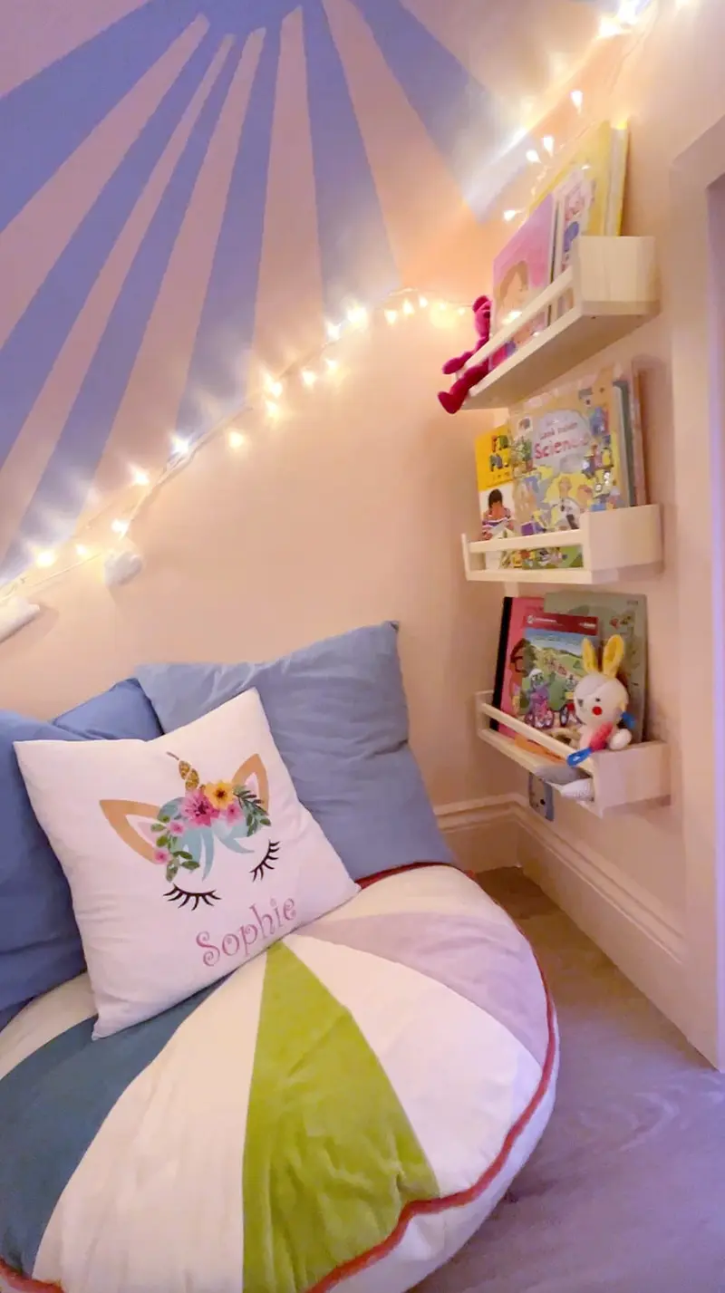 Reading nook with a painted sunburst ceiling and fairy lights