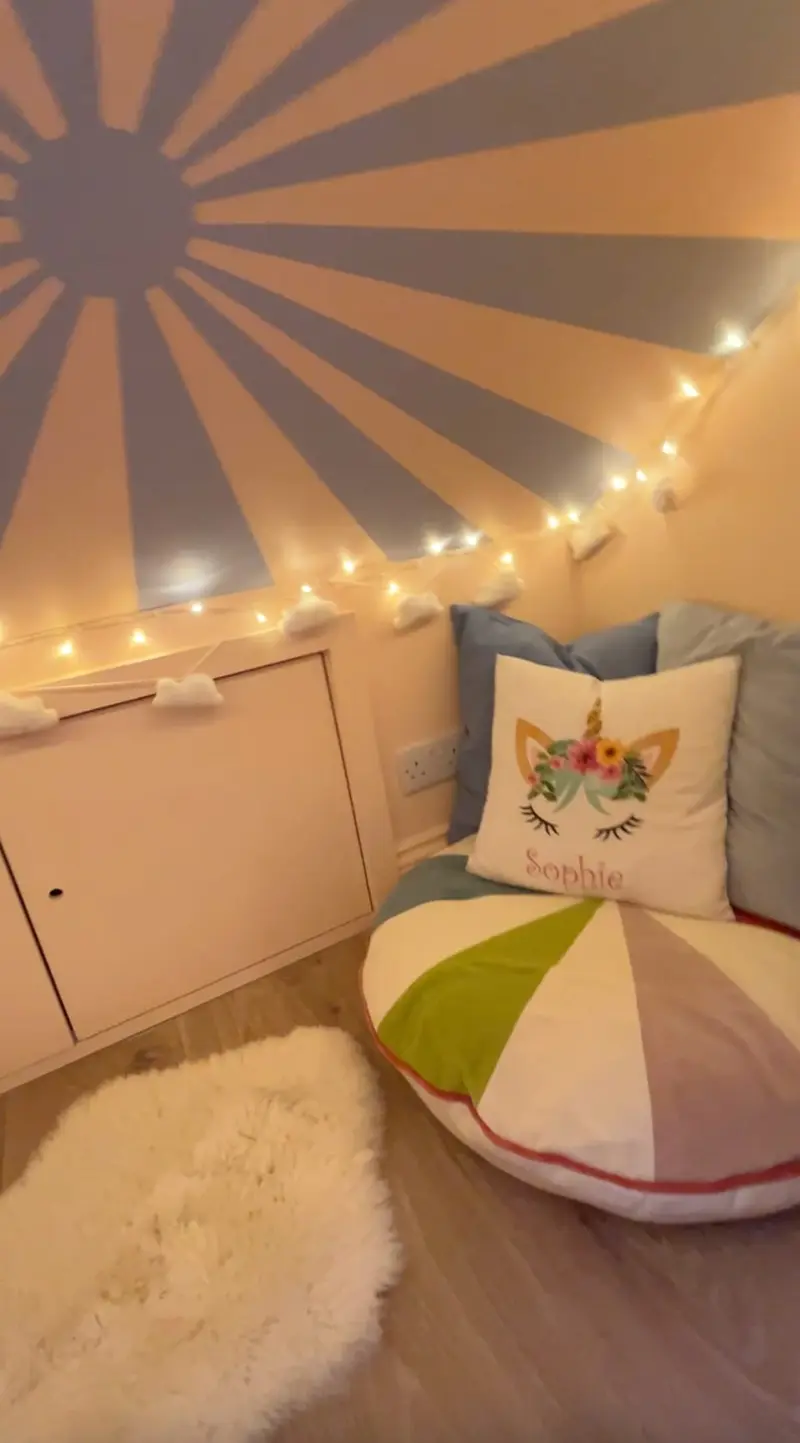 Reading corner with sunburst mural and floor cushion