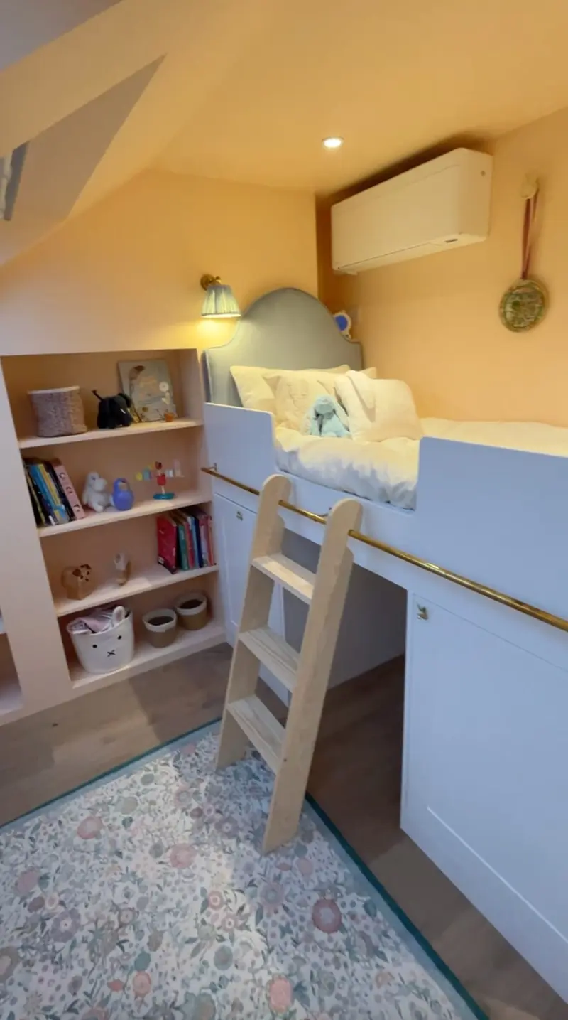 Raised cabin bed with ladder and bookcase