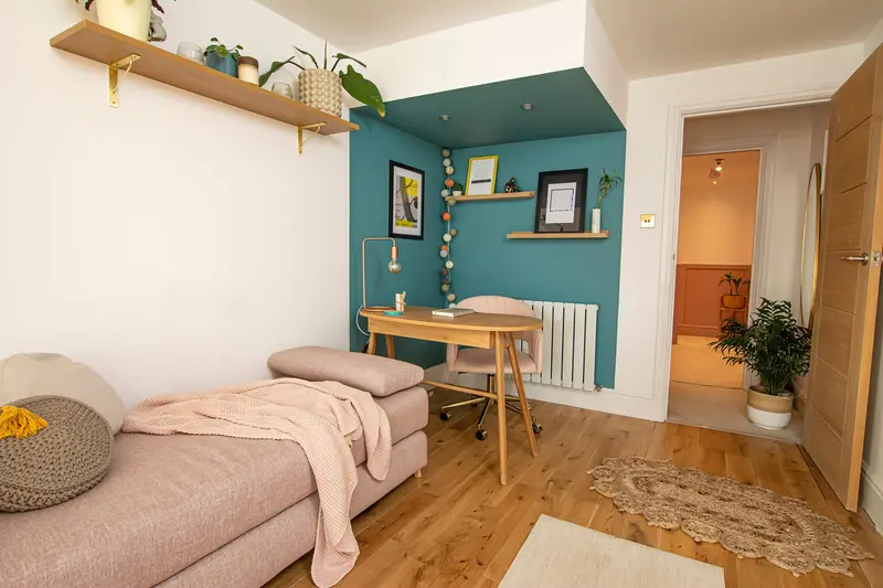 Living area leading to the teal desk nook