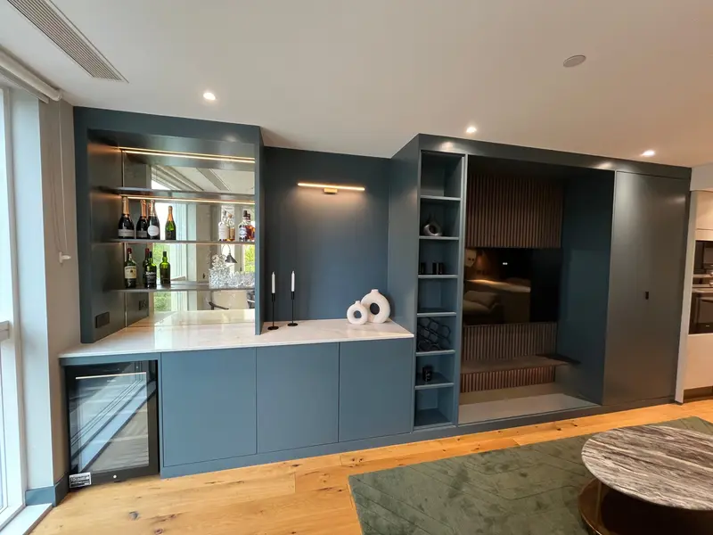 Mirrored bar and built-in navy storage along one wall