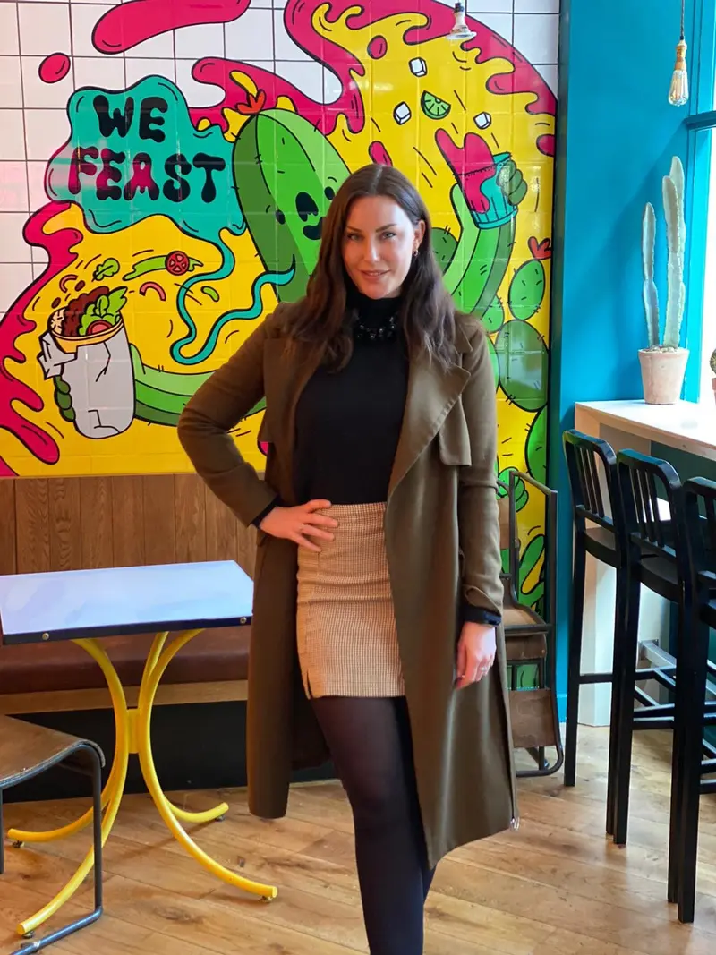 Charlotte on site in a colourful restaurant