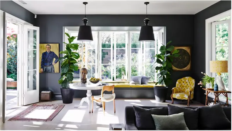 Dark living room with black walls, palms and mustard chair