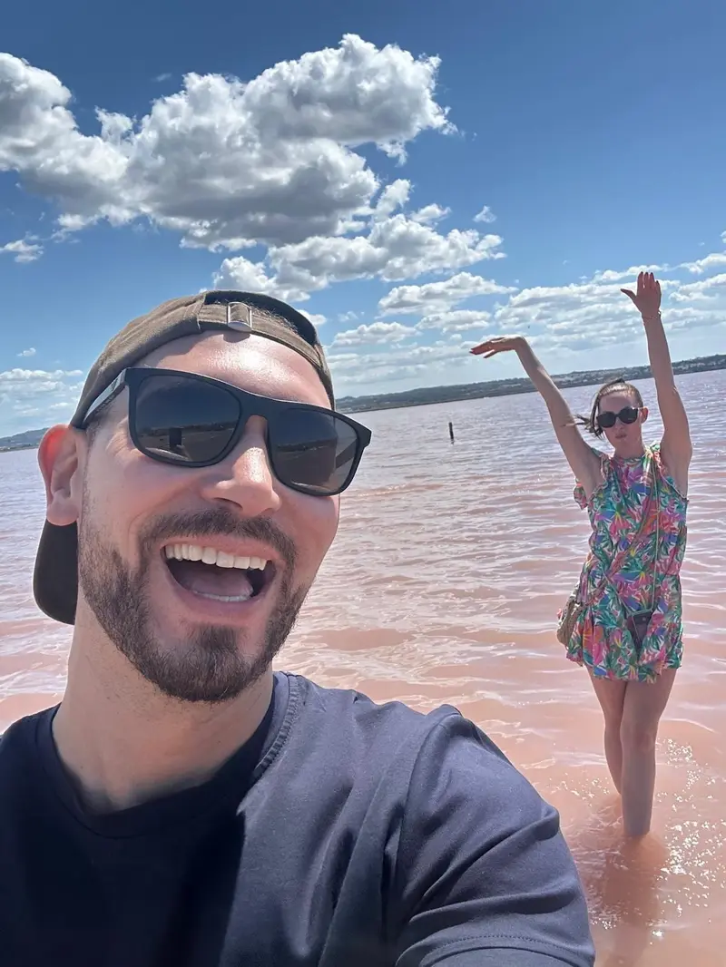 Charlotte and her husband at a pink salt lake in Spain