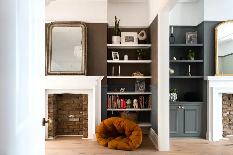 Alcove shelving either side of an exposed brick fireplace