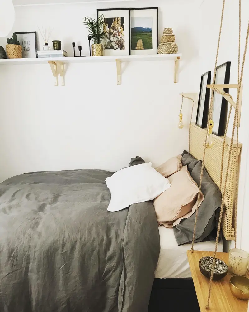 Spare bedroom with framed prints above a linen-dressed bed