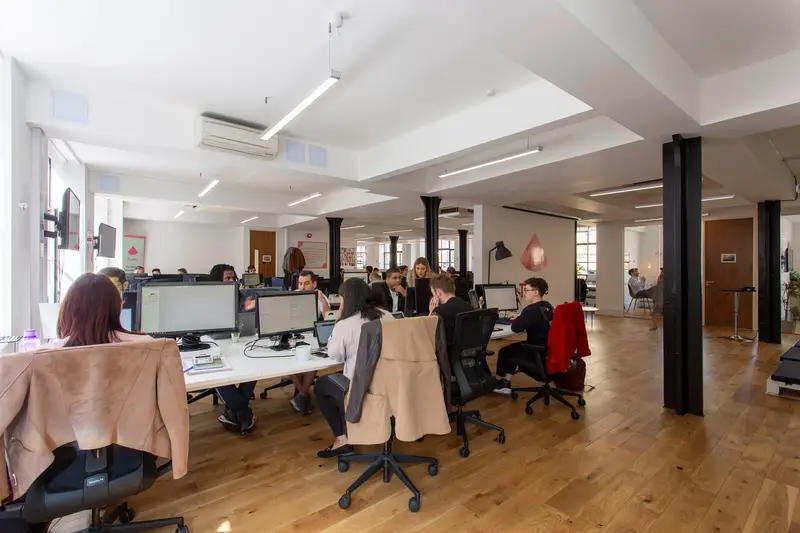 Busy open-plan workspace with timber flooring