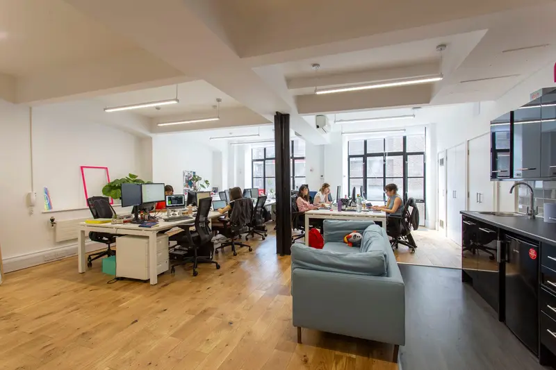 Breakout area with sofa and kitchen in the finished office