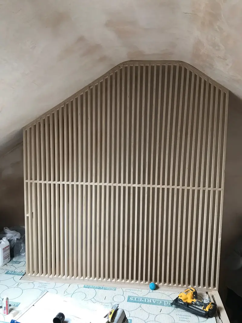 Slatted banister being installed